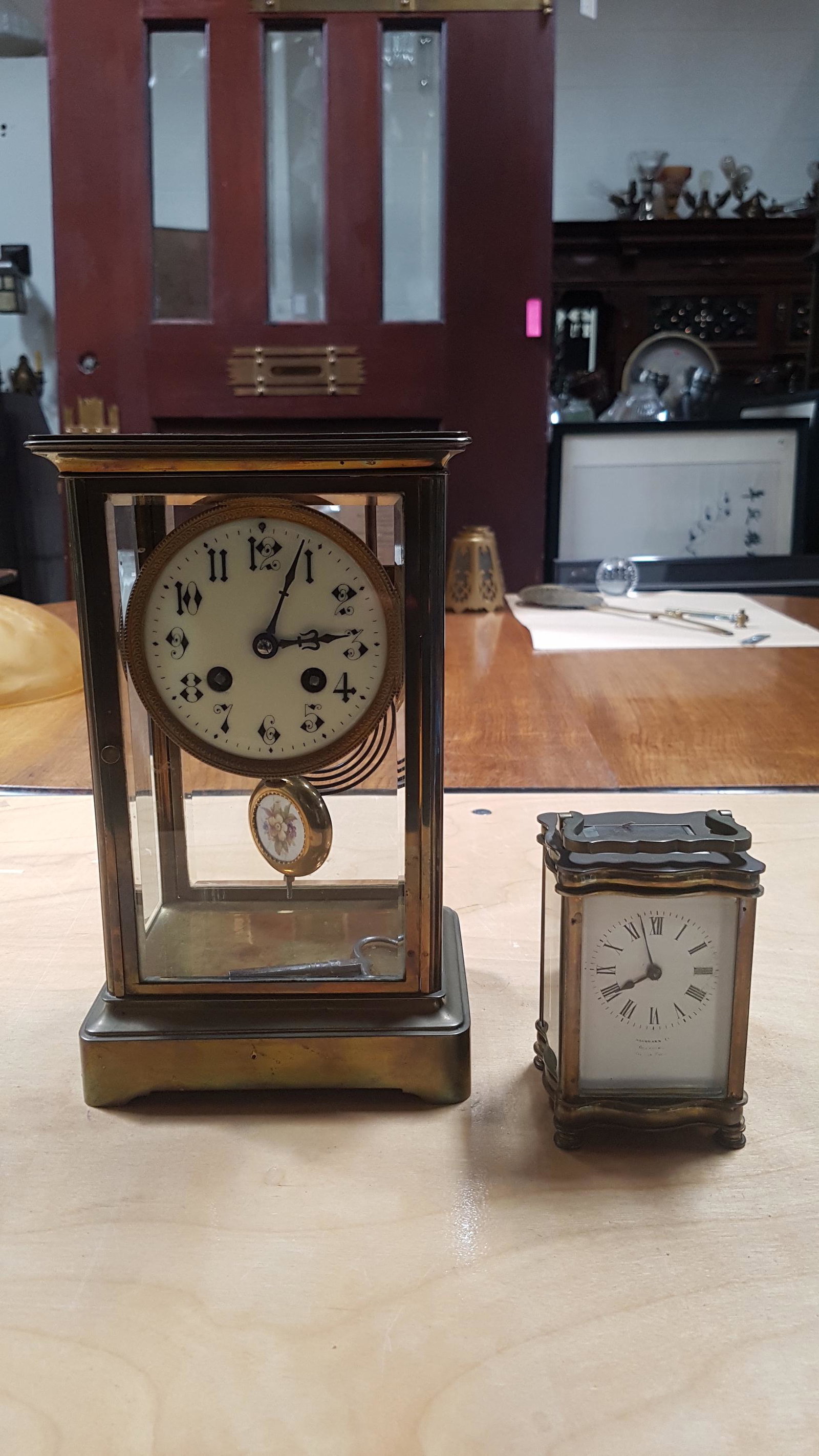 2 Antique Carriage Clocks Very Good Condition: German Petite Carriage Clock with engraved wedding dedication, circa 1912, 6"H x 4"W. Large Carriage Clock with Porcelain Face and Chime, Bevelled Glass on the Case. Key. In working condition, circa 1