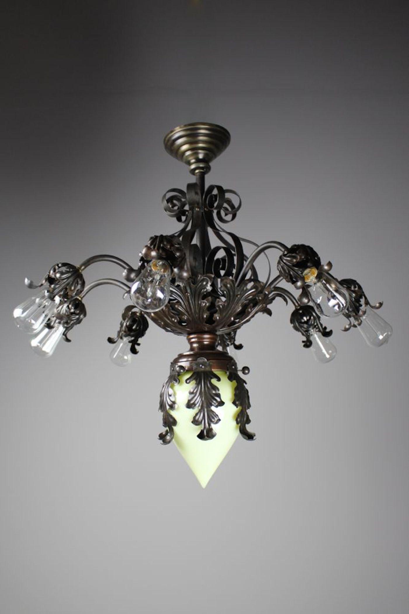 Queen Anne Fancy Wrought Iron Fixture: Circa 1905. This is a rare and decorative wrought iron fixture from the Queen Anne Period; although it was made in America, this chandelier is stylized in a 'Fancy French' almost Rococo manner. Its de