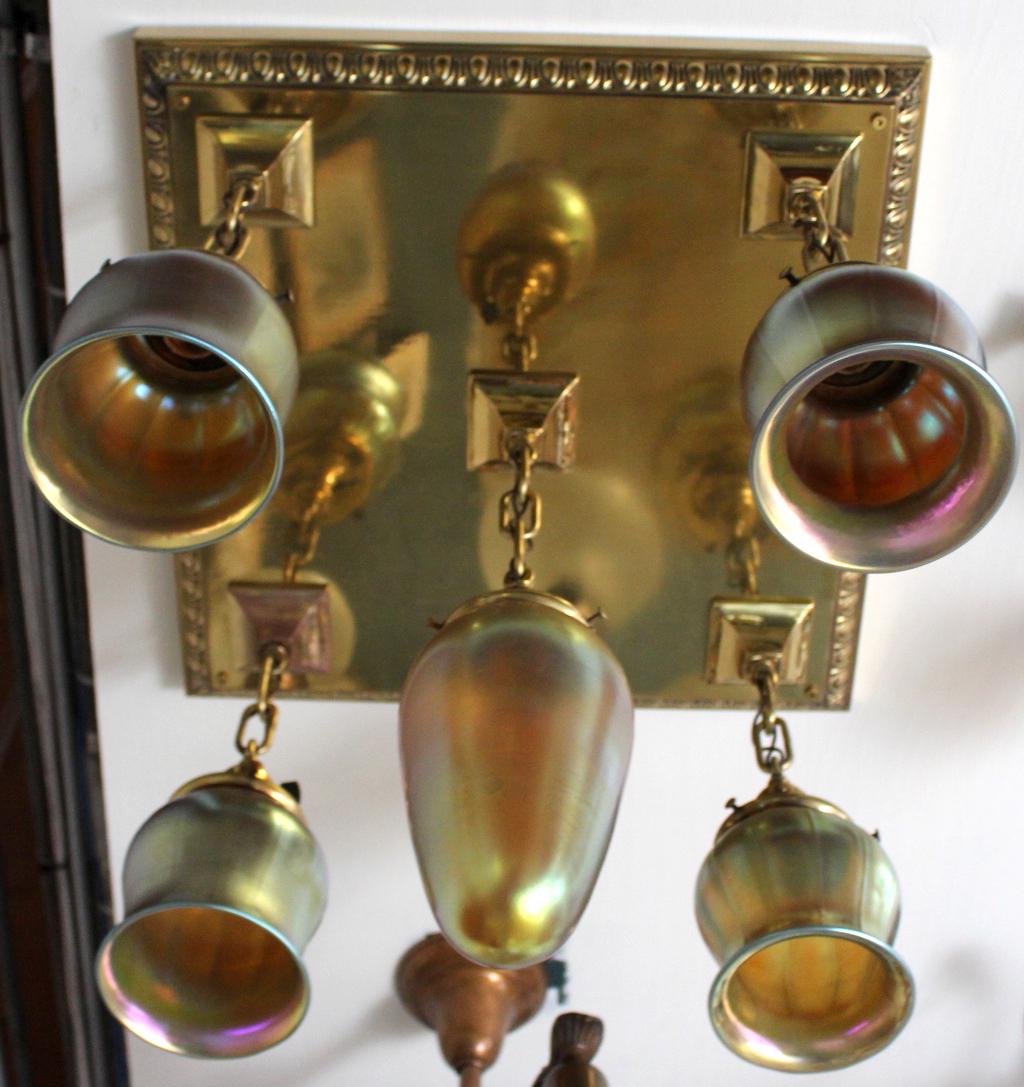 5 Light Polished Brass Flushmount: This sturdy Polished flushmount fixture has great presence. Decorated with scallop design edging and 5 lovely Art Glass shades. C. 1915. Measures 22"L x 20"D