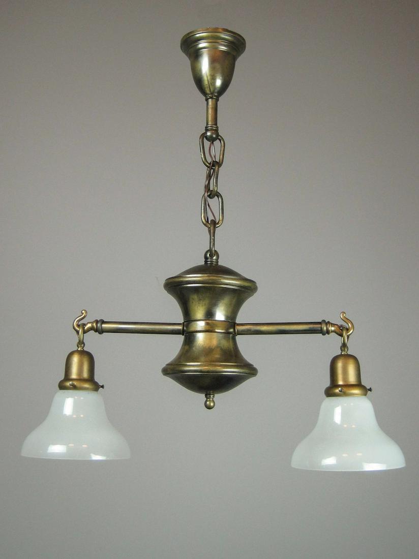 Arts and Crafts Light Fixture (2 Light): Ca. 1914 A unique Arts and Crafts, Mission light fixture comprised of two arms outstretched from a pinched cylindrical body, hooked sockets are fitted with milk glass bell shades. 16"H x 24"W x 28"L