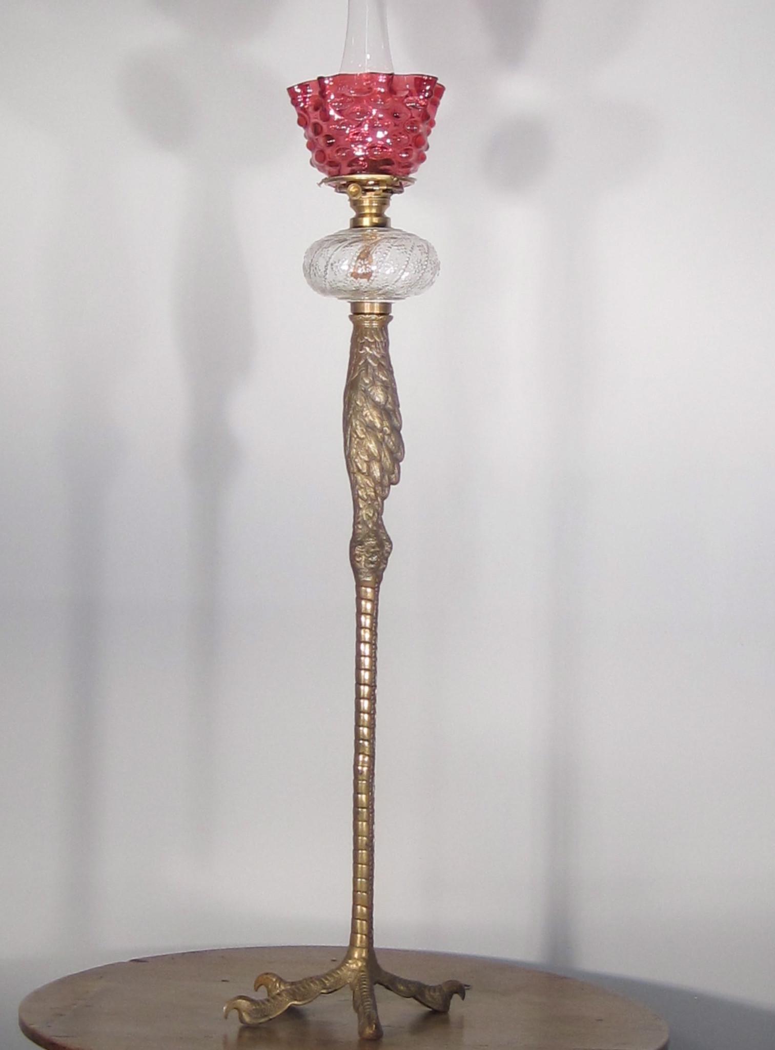 P.E. Guerin Top quality original finish piano lamp: P.E. Guerin Ca. 1880 Top quality original finish piano lamp cast in the shape of a bird's leg. Fitted with its original period cranberry hobnail shade. 43"H