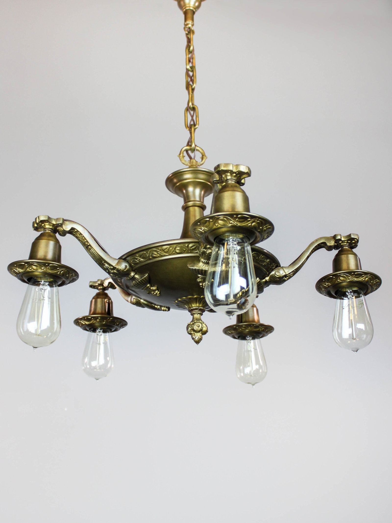 Art Nouveau Bare Bulb Light Fixture (5 light): Ca. 1920 Antique pan light fixture with Art Nouveau embossed motif. Fixture has an original finish with a natural patina. Fully decorated with vines and leaves on body, canopy and bells; restored and 