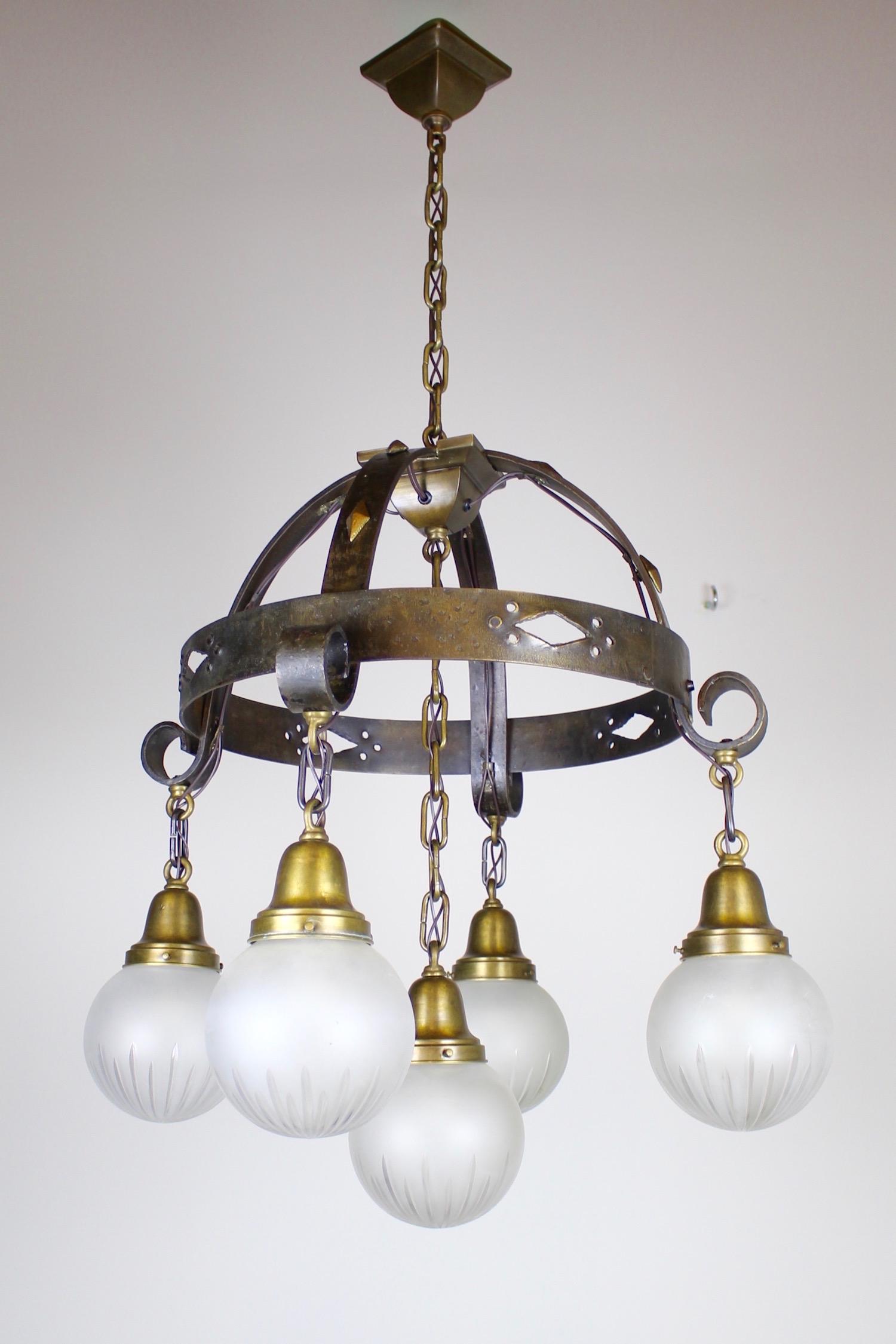 Hammered Arts and Crafts Fixture, Wheel Cut Ball Shades: Circa 1920. This is a wonderful example of handcrafted Arts and Crafts lighting by Beardslee of Chicago. This five light ring fixture is hammered iron with punched cut outs and diamond stud detail. Fi
