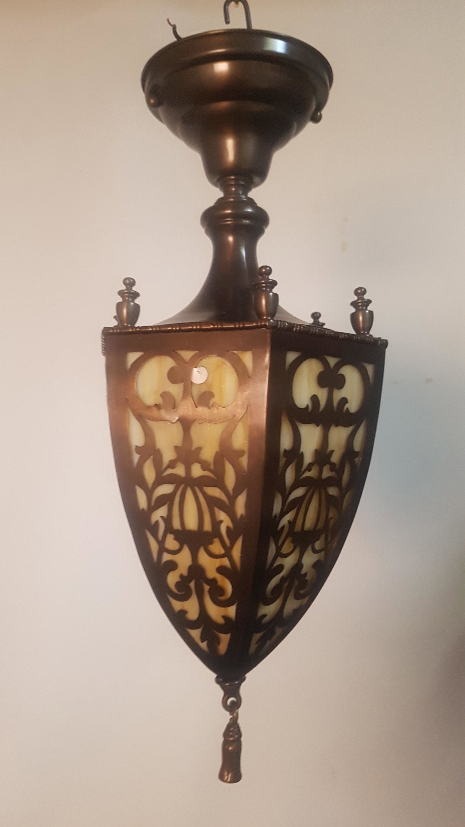 Arts and Crafts Bullet Shaped Pendant Fixture: Arts and Crafts Bullet Shaped Pendant Fixture. Cut out pattern revealing original caramel slag glass. Fully restored. Measures 18.5"H x 8"D. C. 1910.