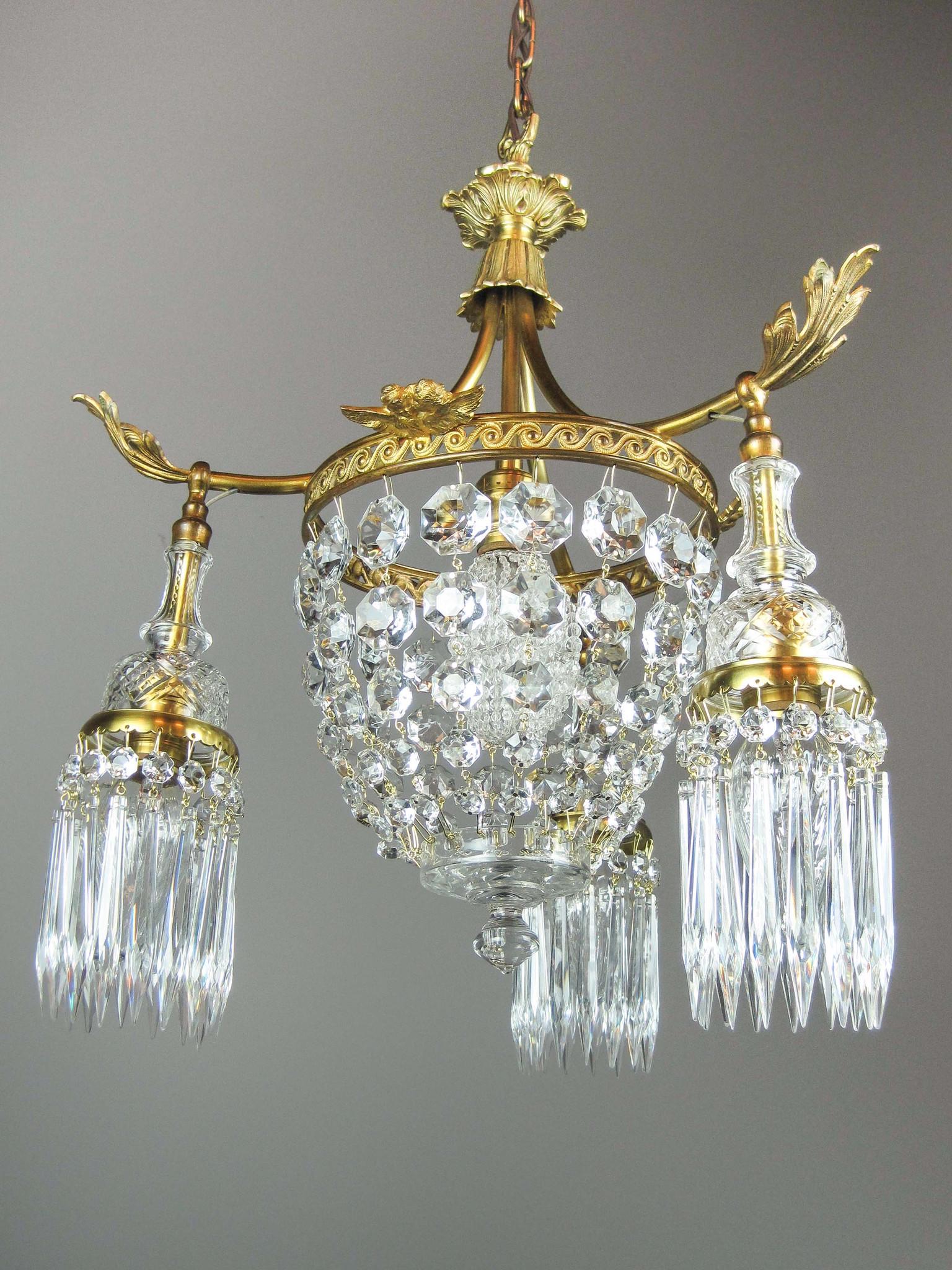 French Empire Crystal Basket Light Cherub Motif (4: Ca. 1912 Crystal French Empire basket light fixture made of brass with all original antique gold plated finish. Attributed to Moran and Hastings (Chicago). Decorative ring is embellished with whimsica