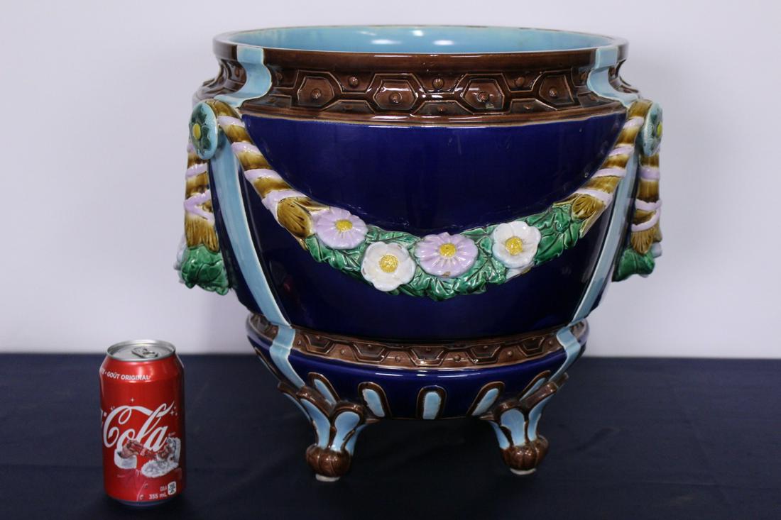 Joseph Holdcroft Monumental Minton Majolica Jardiniere: Rare and Important 19th Century Monumental Minton Majolica Victorian Jardiniere raised on 4 feet. Marked Joseph Holdcroft Bowl is decorated with swags of white and yellow flowers and face masks as han