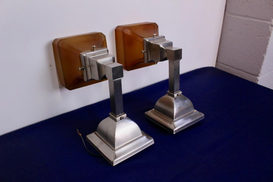 Pair of Arts and Crafts Mission Wall Sconces: Authentic reproduction of Ca.1912 style arts and crafts mission link arm sconces in nickel plate finish with amber shades. Measures 4.5"D x 8"L (with shade)