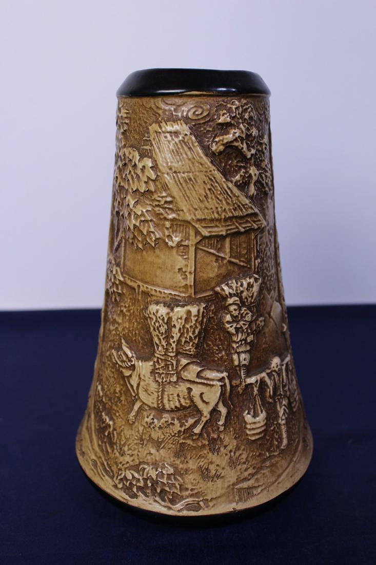Early 20th Century Bretby Art Oriental Motif Pottery: Early 20th Century Bretby Art pottery vase decorated in relief with an Oriental figural scene, impressed factory marks with no.1883 at the bottom, from England, in good condition, each measures 9"H x