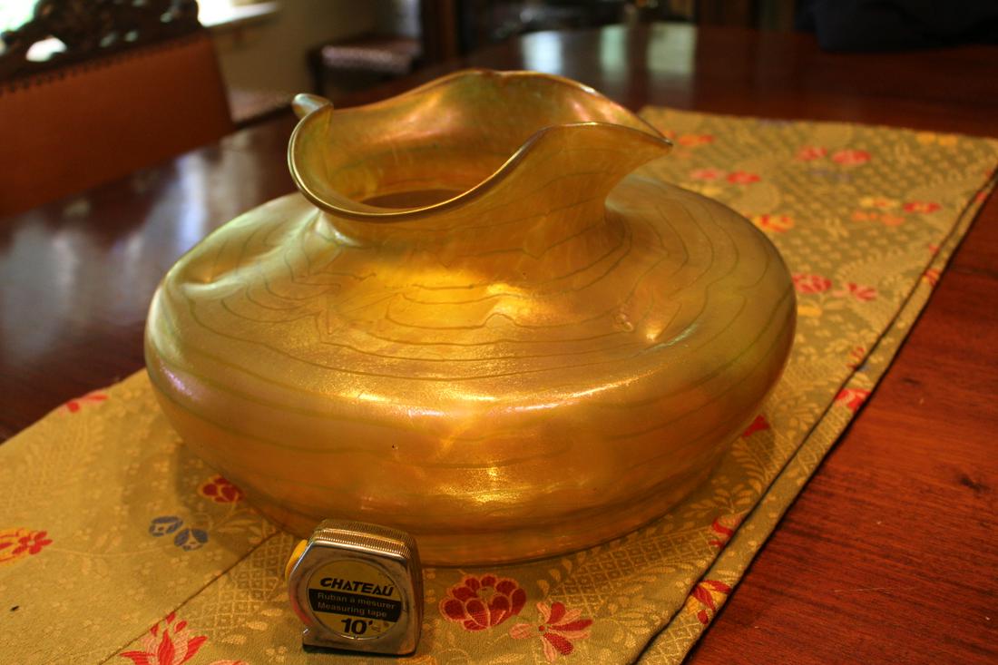 Golden Changeant Art Glass Vase By Otto Thamm for Fritz Heckert: A Gorgeous Golden and Iridescent Changeant Art Glass Vase (previously called Silberband). It is a Loetz type of Art Glass. It was designed by Bohemian Otto Thamm for Fritz Heckert Manufacturing.Unsign