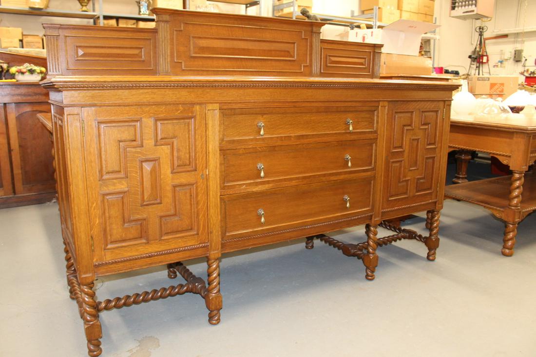 Arts and Crafts Style Buffet with Dinning table and chairs: Arts and Crafts style buffet and room suite consisting of barley twist table and 14 matching chairs. Buffet is with 3 drawers and 2 drawers with doors. Measures 75"Wide x 23 1/2"Depth x 51 1/2"Tall. B