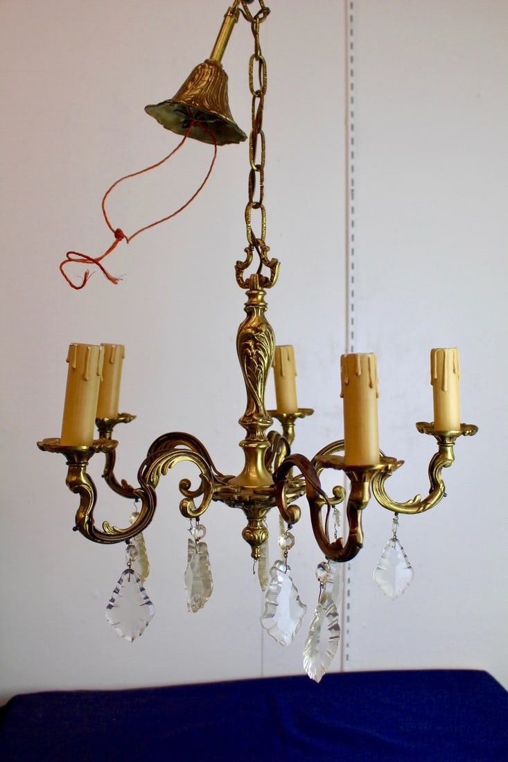 6 Arm French Empire Brass Chandelier with Oval Crystal Droplets: Little French empire brass chandelier with oval crystal droplets. 6 arms with candle tapers. Measures 16"W x 25"H (could be shorten or extended).