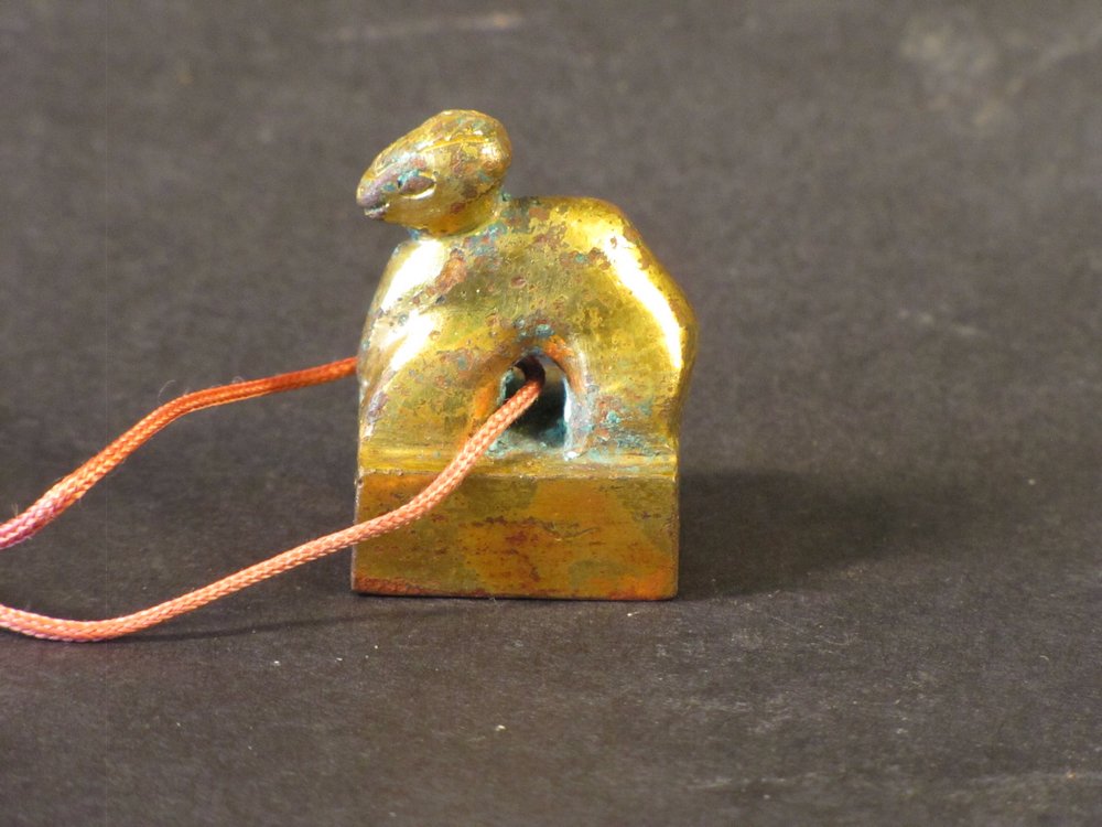 HAN DYNASTY GILT-BRONZE CARVING SEAL: The seal has a gold colour overall. The carving is of a standing camel. H 1 3/4" Han Dynasty