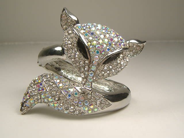 Swarovski Crystal Fox Bangle Bracelet: For auction, a truly remarkable fox bangle bracelet. This bangle features an array of white crystals which outlays the pattern of a fox upon it's silver tone base. This bangle opens to fit any size wr