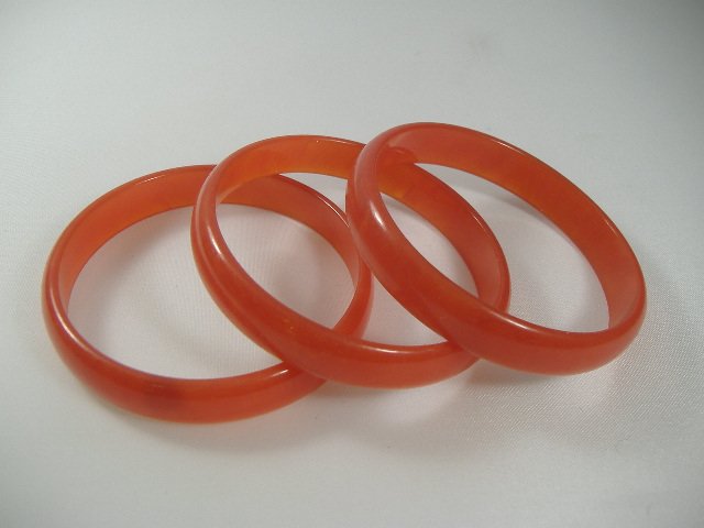 3 Vintage Lucite 1970s Strawberry Bangle Bracelets: Manufactured by Best Plastics of Providence RI in the 1970s. Each Measures approx. 1/2 inch in width and approx. 2 3/4 inches in diameter.