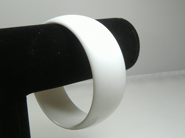 Vintage Lucite 1970s Opal Moonglow Bangle Bracelet: Manufactured by Best Plastics of Providence RI in the 1970s. Original factory stock. The bracelet measures approx. 1 inch in width and approx. 2 3/4 at their maximum diameter.