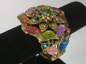 Ann Primrose Crystalleria Designer Bangle Bracelet: From the Ann Primrose Collection comes this opportunity to own a masterpiece! Chunky, Attention grabbing, and sleek, this bangle will be the talk of any gathering! The angular crystals glare as light 