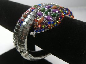 Ann Primrose Crystalleria Designer Bangle Bracelet: From the Ann Primrose Collection comes this opportunity to own a masterpiece! Chunky, Attention grabbing, and sleek, this bangle will be the talk of any gathering! The angular crystals glare as light 