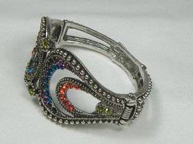 Ann Primrose Crystalleria Designer Bangle Bracelet: From the Ann Primrose Collection comes this opportunity to own a masterpiece! Chunky, Attention grabbing, and sleek, this bangle will be the talk of any gathering! The angular crystals glare as light 