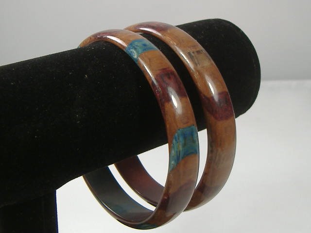 Set of 2 Vintage Lucite Bangle Bracelets: 2 Vintage Lucite Bangle Bracelets. Manufactured by Best Plastics of Providence RI in the 1970s. Measures approx. 2 3/4 inches at their maximum width