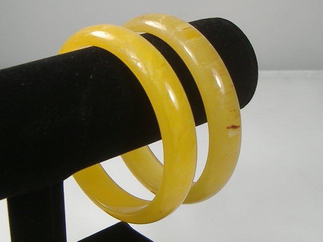 Set of 2 Vintage Lucite Bangle Bracelets: 2 Vintage Lucite Bangle Bracelets. Manufactured by Best Plastics of Providence RI in the 1970s. Measures approx. 2 3/4 inches at their maximum width