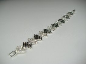 Ann Primrose Crystalleria Designer Tennis Bracelet: From the Ann Primrose Collection comes this opportunity to own a masterpiece! Chunky, Attention grabbing, and sleek, this bangle will be the talk of any gathering! The angular crystals glare as light 