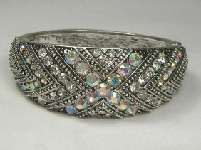 Ann Primrose Crystalleria Designer Bangle Bracelet: From the Ann Primrose Collection comes this opportunity to own a masterpiece! Chunky, Attention grabbing, and sleek, this bangle will be the talk of any gathering! The angular crystals glare as light 