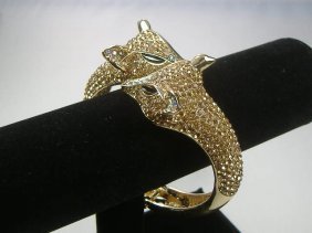 Crystalleria Designer Bangle Bracelet: From the Ann Primrose Collection comes this opportunity to own a masterpiece! Chunky, Attention grabbing, and sleek, this bangle will be the talk of any gathering! The angular crystals glare as light 