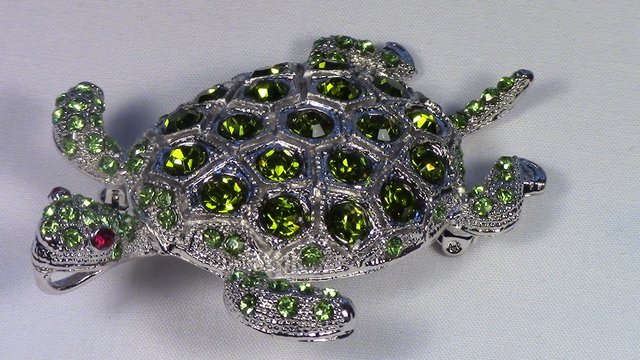 Crystalleria Designer Pin/Brooch: From the Ann Primrose Collection comes this opportunity to own a masterpiece! Chunky, Attention grabbing, and sleek, this pin will be the talk of any gathering! The angular crystals glare as light hit