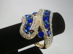 Crystalleria Designer Bangle Bracelet: From the Ann Primrose Collection comes this opportunity to own a masterpiece! Chunky, Attention grabbing, and sleek, this bangle will be the talk of any gathering! The angular crystals glare as light 
