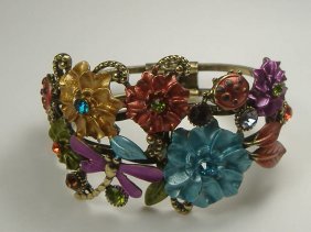 Crystalleria Designer Bangle Bracelet: From the Ann Primrose Collection comes this opportunity to own a masterpiece! Chunky, Attention grabbing, and sleek, this bangle will be the talk of any gathering! The angular crystals glare as light 