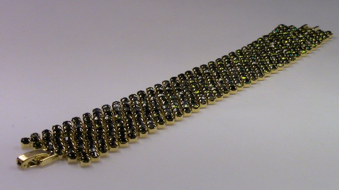 Crystalleria Designer Tennis Bracelet: From the Ann Primrose Collection comes this opportunity to own a masterpiece! Chunky, Attention grabbing, and sleek, this bangle will be the talk of any gathering! The angular crystals glare as light 