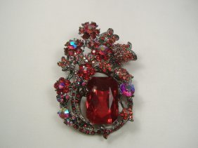 Swarovski Crystal Element Pin Brooch: Chunky, Attention grabbing, and sleek, this pin will be the talk of any gathering! The angular crystals glare as light hits their surface at different angles. Caste in molten metal, formed, high quali