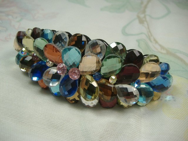 Swarovski Crystal Element Hair Clip: Chunky, attention grabbing, and sleek, this hair clip will be the talk of any gathering! The angular crystals glare as light hits their surface at different angles. Caste in molten metal, formed, high