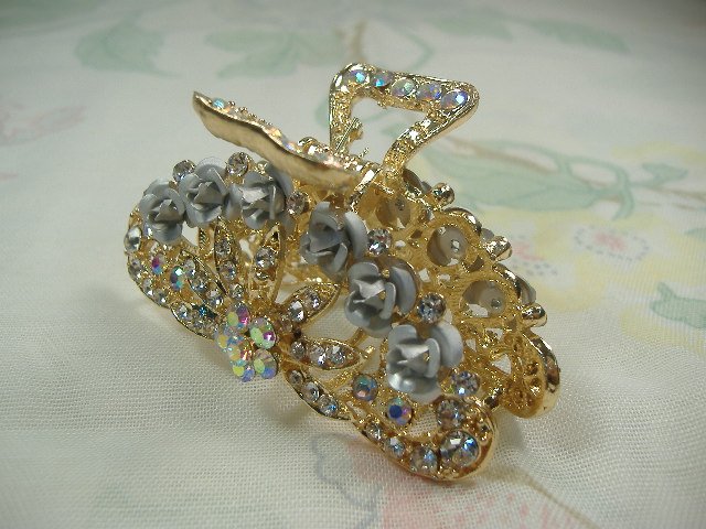 Swarovski Crystal Element Hair Clip: Chunky, attention grabbing, and sleek, this hair clip will be the talk of any gathering! The angular crystals glare as light hits their surface at different angles. Caste in molten metal, formed, high