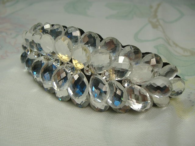 Swarovski Crystal Element Hair Clip: Chunky, attention grabbing, and sleek, this hair clip will be the talk of any gathering! The angular crystals glare as light hits their surface at different angles. Caste in molten metal, formed, high