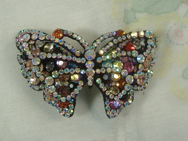 Swarovski Crystal Element Hair Clip: Chunky, attention grabbing, and sleek, this hair clip will be the talk of any gathering! The angular crystals glare as light hits their surface at different angles. Caste in molten metal, formed, high