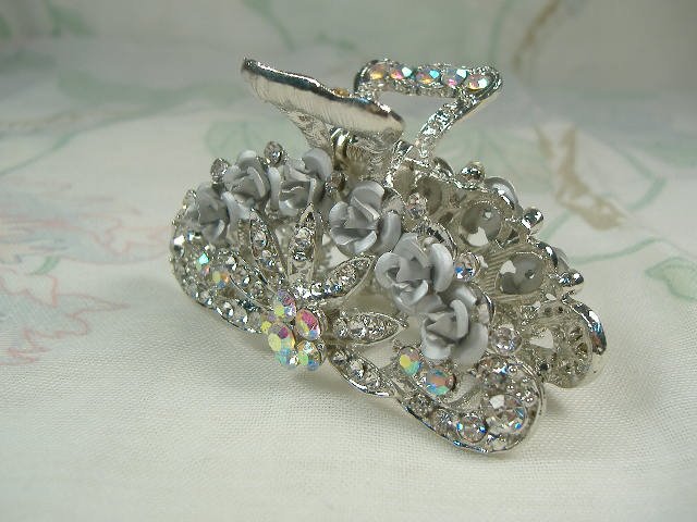 Swarovski Crystal Element Hair Clip: Chunky, attention grabbing, and sleek, this hair clip will be the talk of any gathering! The angular crystals glare as light hits their surface at different angles. Caste in molten metal, formed, high