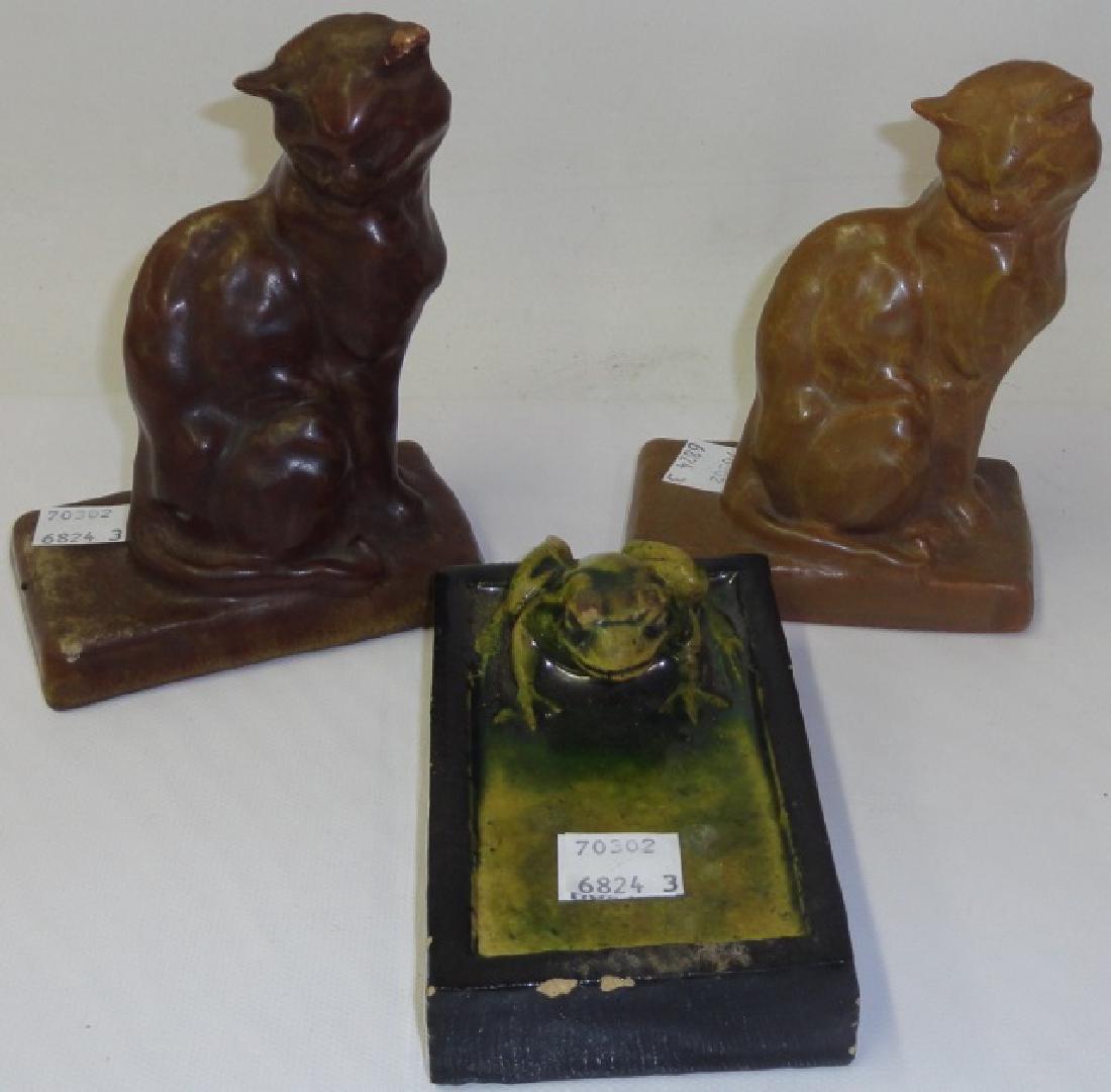 *3 PIECES OF ART POTTERY: Pair of Rookwood figural bookends depicting seated cats, dated 1912, approximate height 5 1/2", and unmarked paperweight depicting frog, height 2 1/2".