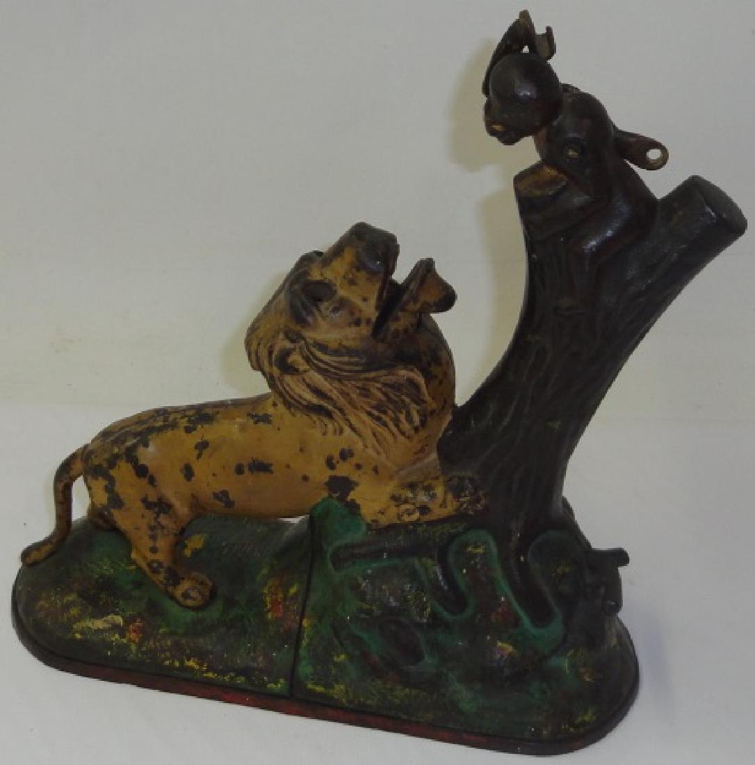 *CAST IRON MECHANICAL BANK: Lion attacking monkey, approximate height 9 1/4".