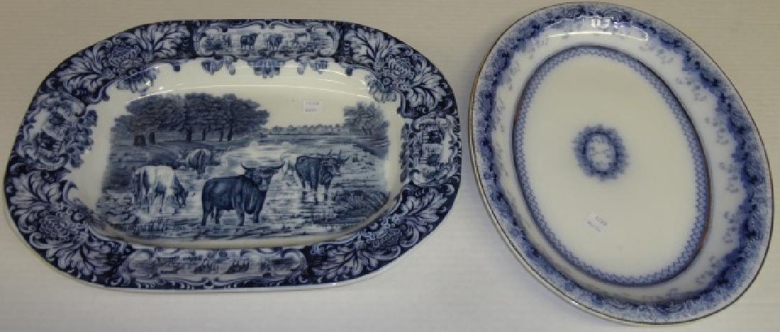 *2 FLOW BLUE PLATTERS: 1 oval "Chaplet" pattern by J. & G. Meakin, approximate width 16 3/4", and 1 oval by Wedgwood & Co. decorated with bucolic scene, width 16 1/2".