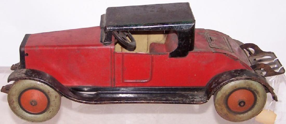 *HERCULES BALLOON CORD CAR: Red and black, complete with jump seat, luggage rack, and front and back license plates, appears to be all original, approximate length with luggage rack down 18 1/2".