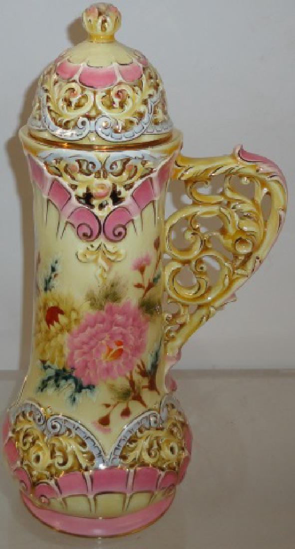 ZSOLNAY PORCELAIN TANKARD: Having floral decoration, approximate height 12 1/2".