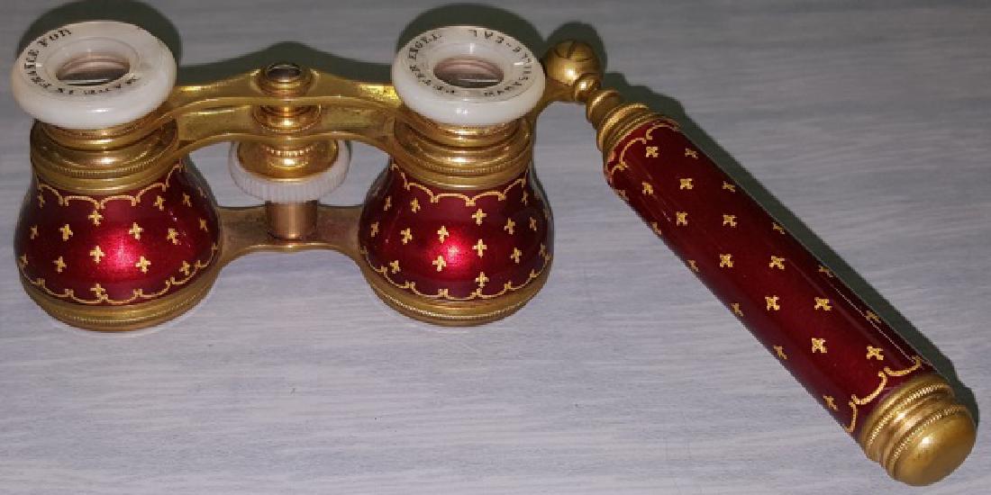 *PAIR OF ENAMEL OPERA GLASSES: Enamel lorgnette, handle and body having red enamel with gilt fleur de lis design, mother-of-pearl eye cups marked "Made in France for Peter Engel, Marysville-Cal", with telescopic handle.