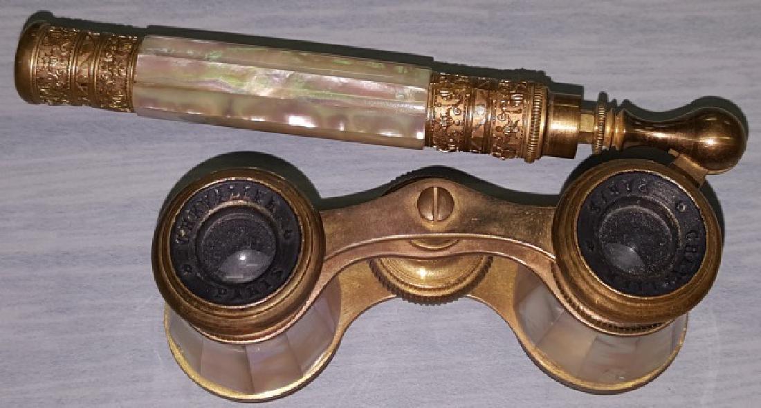 *PAIR OF MOTHER-OF-PEARL AND BRASS OPERA GLASSES: Mother-of-pearl and brass lorgnette, mother-of-pearl body, handle has mother-of-pearl center with pierced ormolu mounts at both ends, eye cups marked "Chevalier Paris", with telescopic handle.