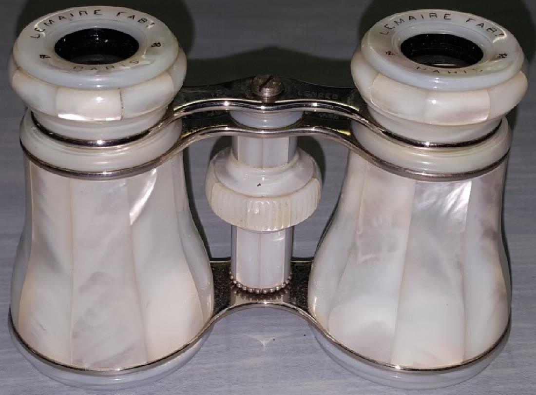 *PAIR OF MOTHER-OF-PEARL OPERA GLASSES: Mother-of-pearl on body, stem, post, and eye cups, marked on eye cups "LeMaire FABt Paris", having silver bridges, 1 marked "Made in France", comes with black case.