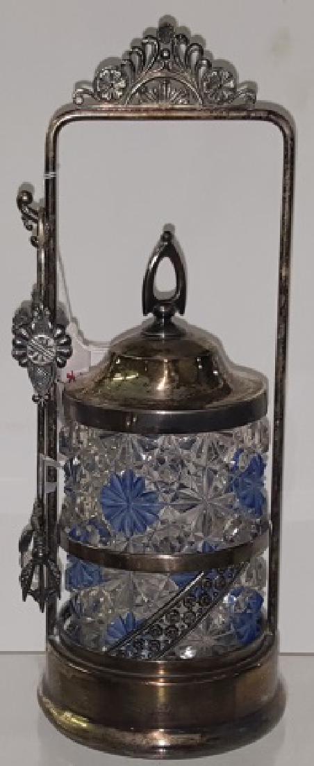 *VICTORIAN PICKLE CASTOR: Having clear glass jar with blue painted floral decoration, with silverplate stand, complete with tongs, approximate height 11 3/8".