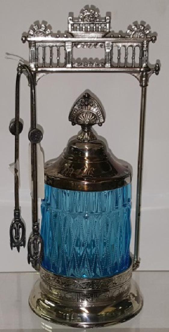 *VICTORIAN PICKLE CASTOR: Having blue glass jar, with silverplate stand, complete with tongs, approximate height 10 3/8".