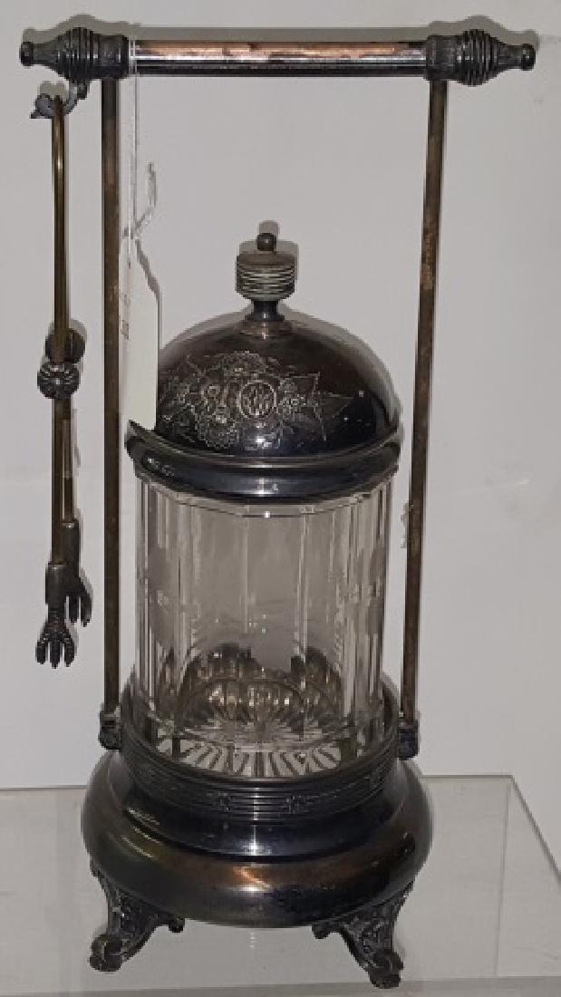 *VICTORIAN PICKLE CASTOR: Having clear glass jar with etched decoration, with silverplate stand, complete with tongs, approximate height 11 3/8".