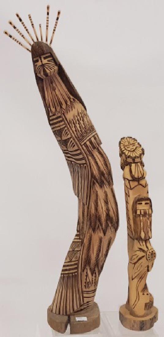 *2 CARVED WOOD HOPI KACHINAS: 1 marked on underside "Humming Bird Kachina Bring Blessing to the Family Hopi R Henry 1-16-04", approximate height 24 1/2", and 1 marked "Sunface Kachina & Long Hair Kachina Hopi D. Nelson 1-16-04", h