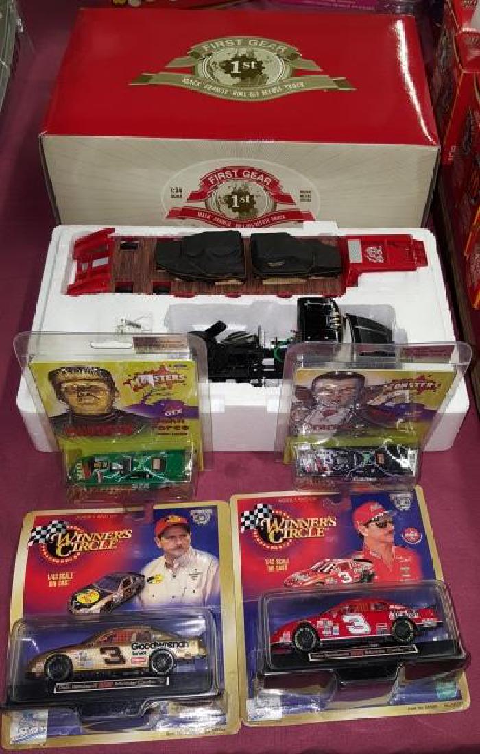 *GROUP OF TOY CARS: 2 NASCAR, 2 Monsters, and 2 Mack trucks, all but 1 with original boxes.